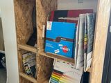 a book shelf that has a lot of books on it