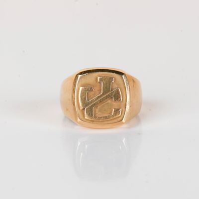 Gros plan sur une bague en or ornée d'une croix