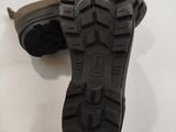 a close up of a pair of black shoes on a white surface