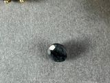 two pieces of jewelry sitting on top of a table next to each other
