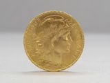 a close up of a gold coin with a woman ' s face on it