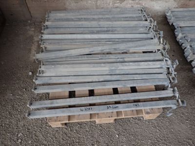 several wooden pallets are stacked on top of each other on the ground