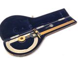 a small musical instrument in a case on a white surface
