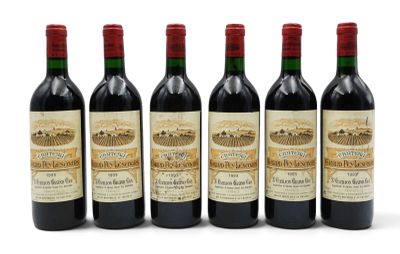 six bottles of wine are lined up on a white surface