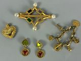 several different types of jewelry including a brooch, earrings, and a cross