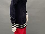 an image of a mannequin wearing a red skirt and black sweater