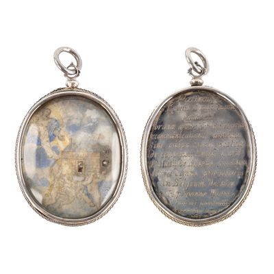 two oval silver pendants with a picture of a man and a woman