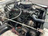 an old car engine that is sitting in the back of the truck