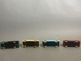 five different colors of guitar pedals lined up in a row