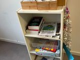 a book shelf with books on top of it in a room