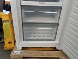 an open refrigerator sitting on a pallet in a warehouse