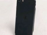 the back of a black iphone with a charging dock on top of it