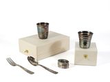 a silverware set on a white box with a fork and spoon