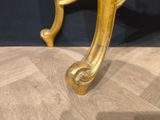 an image of a gold colored chair with a black background