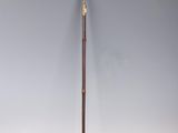 an old cane with a wooden handle and a metal handle on a white surface