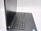 the laptop is open on a white surface with a red button on the keyboard