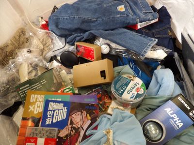 a pile of clothing and other items in a suitcase