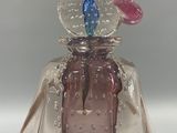 a glass bell with a bird on top of it