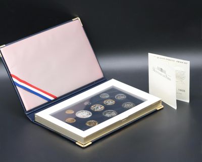 a box of coins sitting on a table next to a card