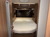 a small bed in the middle of a small room