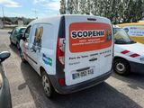 a white van parked in a parking lot next to other cars