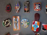 a lot of badges that are on a table
