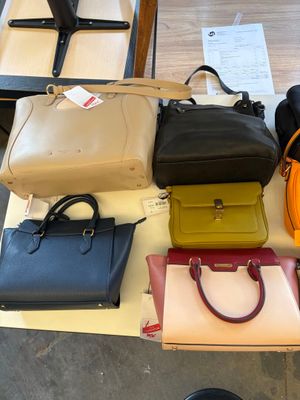 a lot of purses that are on a table