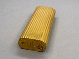 a gold lighter that is sitting on a table