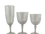 three clear glass goblets sitting next to each other on a white surface