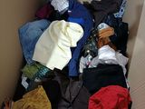 a cardboard box full of clothes and clothes that are in it