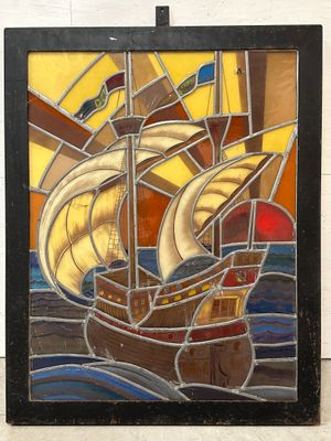 stained glass picture of a sailboat in the ocean with a sail