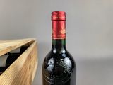 a bottle of wine that is sitting next to a wooden box