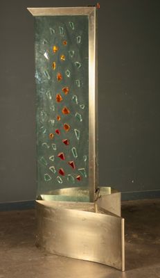 a sculpture of a glass and metal structure in the middle of a room