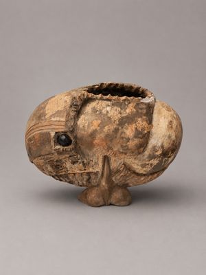 an image of a vase with a fish on it on a gray surface