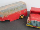 a red and blue toy truck next to a red and white toy truck