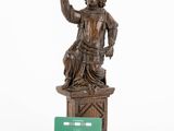statue of a man with a green card in his hand