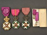 three medals are in a box on a table next to other items