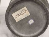 a label on the bottom of a vase that is sitting on a table