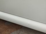 a close up of a white car with a hole in the side of it