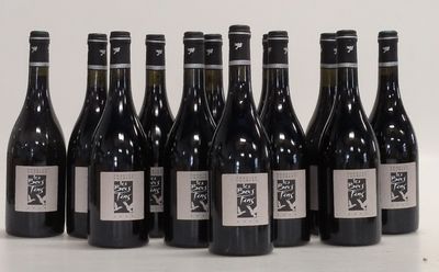 six bottles of wine are lined up in a row on a table