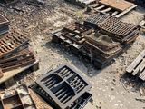 a lot of old wooden crates and other items on the ground
