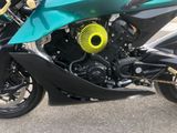 a green motorcycle parked on the side of the street