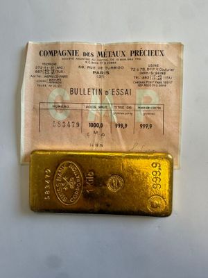a gold bar sitting on top of a piece of paper
