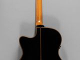 the back of a black acoustic guitar on a white background
