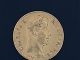 l'image d'une pièce d'or sur laquelle figure le portrait d'une femme