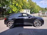 a picture of a black suv parked in a parking lot