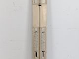 a tall clock that is on the wall next to a white wall