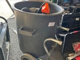 an image of a trash can with tools in it