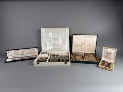 several different types of silverware in a case on a gray surface