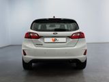 the rear end of a white ford fiesta parked in a white room